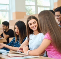 Smiling students talking during lesson.